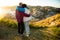 Loving mature couple traveling, standing on the top of rock, exploring