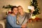 Loving millennial couple making selfie on Christmas eve