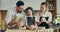 Loving mom with father teaching curious kid daughter learning kneading dough, preschooler daughter helping mother