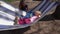 Loving mom swing son and daughter lying on hammock. Gimbal motion