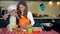 Loving mother with her excited cute daughter girl sifting flour in kitchen