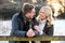 Loving Newly Engaged Couple Leaning On Fence On Snowy Walk In Winter Countryside