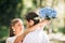 Loving Newlyweds Embracing Standing In Park During Ceremony