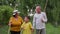 loving older parents with their grandchild in fresh air, little boy walks with grandmother and grandfather holding