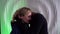 Loving pair of blonde caucasian woman and black man, lovers are kissing and embracing