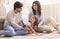 Loving Parents Drawing With Little Daughter On Floor In Living Room