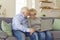 Loving senior couple communicating or ordering something online on laptop at home