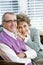 Loving senior couple sitting together on couch