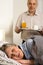 Loving senior husband serving breakfast to wife