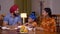 Loving Sikh family having lunch together in a dining room -  family love