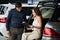 Loving smart couple choosing a car at the car dealership showroom