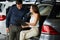 Loving smart couple choosing a car at the car dealership showroom