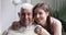 Loving smiling young granddaughter hug old grandfather, family portrait