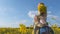 A loving son hugs his mother in a rapeseed field.