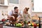 Loving young Asian couple cooking in kitchen making healthy food