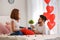 Loving young couple drinking coffee on bed at home. Celebration of Saint Valentine\'s Day