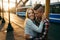 Loving young couple is hugging during the sunset in the street. Emotional close-up portrait.