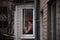 A loving young couple hugs in the window of their balcony terrace in the apartment