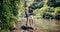 Loving young couple standing by mountain stream