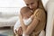 Loving young mother caress newborn baby infant