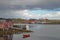 Lovund harbor with red houses on sunny summer morning