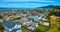 Low aerial over rich houses in Tiburon overlooking houses in Paradise Cay Yacht Harbor