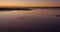 Low aerial shot on the beach at sunset with low tide