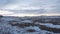 Low aerial tilt reveal flight over a winter wheat field