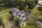 Low aerial view of beautiful residential home on large  property