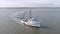 Low aerial view of a shrimp boat pulling nets off the coast of South Carolina, USA