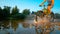 LOW ANGLE: Active man riding his mountain bike and splashing refreshing water.