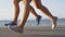 LOW ANGLE: Active young couple bonds through working out together at the beach.