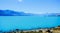 Low-angle of Aoraki(Mount) Cook mountain with lake view sunlit clear sky background