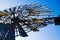 Low angle close up of isolated antique metal wind wheel turbine on steel tower against blue cloudless sky near Zaanse Schans,