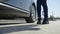 Low angle close up shot of young girl feet legs get out from black car sunny day and start dancing