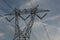 Low angle closeup of electricity transmission tower in residential neighborhood