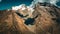 Low-angle closeup of a sunlit rocky mountain clouds and sky background