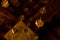 Low angle detail of a golden diamond hanging from the wooden ceiling of the granollers porch