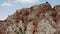 Low angle drone shot of Armenian giant, tall brick red cliffs and rocks near Noravank monastery