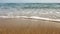 Low angle / ground level photo of wet sand on the beach, sea in