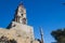 Low angle of the historical Medieval Clock Tower Roloi under the blue sky in Rhodes, Greece