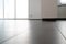 Low angle horizontal view of a new black ceramic tile floor in a bright white light apartment