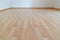 Low angle horizontal view of new wooden parquet flooring in a bright light and white apartment room