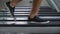 Low angle of leg and shoes man running on treadmill in fitness gym at sport club . motivation and workout . closeup foot and