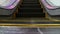 Low angle looped perspective view of modern escalator stairs. Automated elevator mechanism. Yellow line on stairway