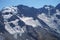 Low-angle of misty, ridged mountain covered with snow