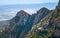 Low-angle of Montserrat forested mountain peak sunlit clear sky background