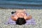 Low angle of a pregnant woman sunbathing on the beach