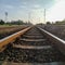 Low angle railway scenery with clean sky background. Metal sleepers on the railway.