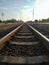 Low angle railway scenery with clean sky background. Metal sleepers on the railway.